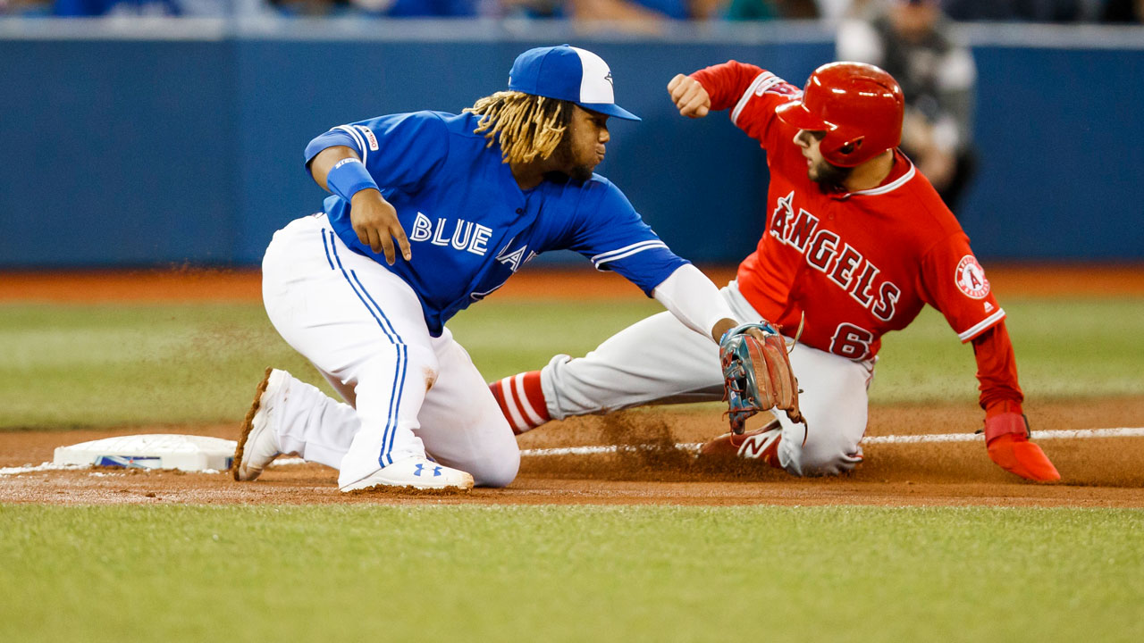 Los Angeles Angels' David Fletcher slides into third safely against Toronto Blue Jays' Vladimir Guerrero Jr. (Mark Blinch/CP)
