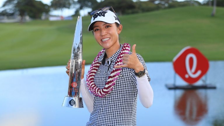 Lydia Ko, of New Zealand, holds the Lotte Championship trophy after winning the golf tournament, Saturday, April 17, 2021, in Kapolei, Hawaii. (Marco Garcia/AP)
