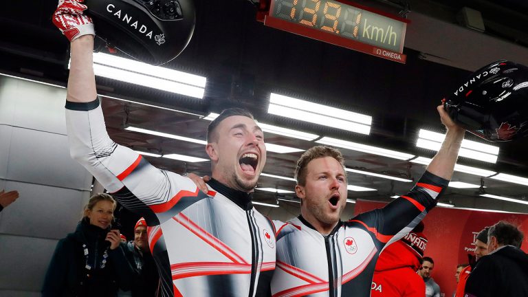 Alexander Kopacz, left, alongside Justin Kripps, right, after tying for the gold with Germany during the two-man bobsled final at the 2018 Winter Olympics in Pyeongchang, South Korea, Monday, Feb. 19, 2018. (Andy Wong/AP)