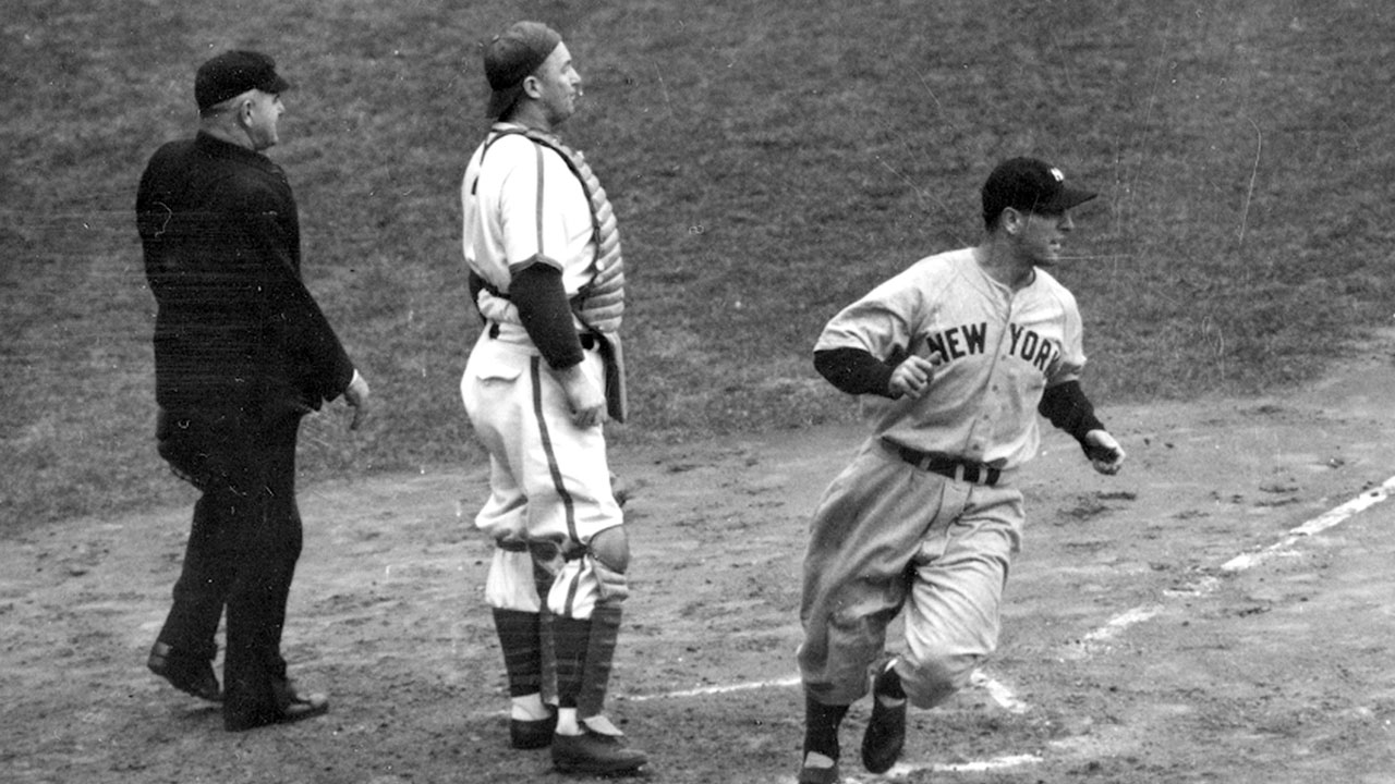 New York Yankees' Lou Gehrig scores the first run of the 1938 World Series against the Chicago Cubs as he crosses home plate in the second inning of Game 1 at Wrigley Field in Chicago. (AP Photo)