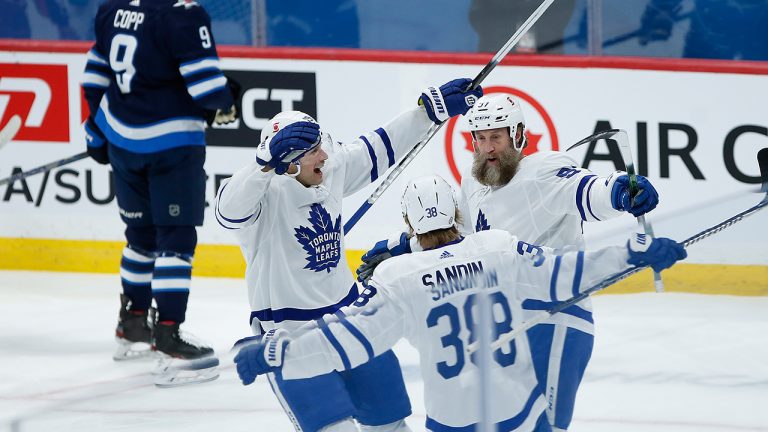 Toronto Maple Leafs' Jason Spezza (19), Rasmus Sandin (38) and Joe Thornton (97) celebrate Thornton's goal against the Winnipeg Jets during first period action in Winnipeg on Saturday, April 24, 2021. (John Woods/CP)