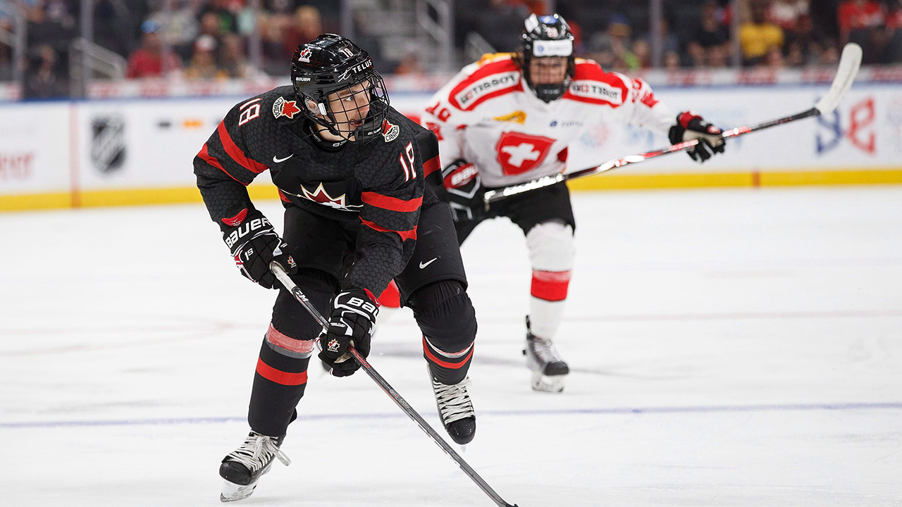 Canada's Maxence Guenette (8) is pursued by Switzerland's Theo Rochette (20) during first period round-robin Hlinka Gretzky Cup hockey action in Edmonton on Monday, August 6, 2018. (Codie McLachlan/CP)