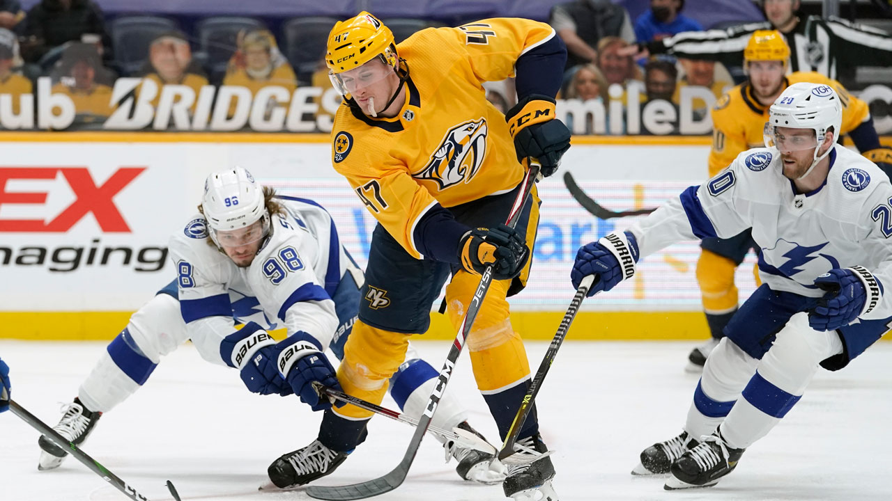 Tampa Bay Lightning defenseman Mikhail Sergachev (98) battles for the puck with Nashville Predators right wing Michael McCarron (47). (Mark Humphrey/AP)