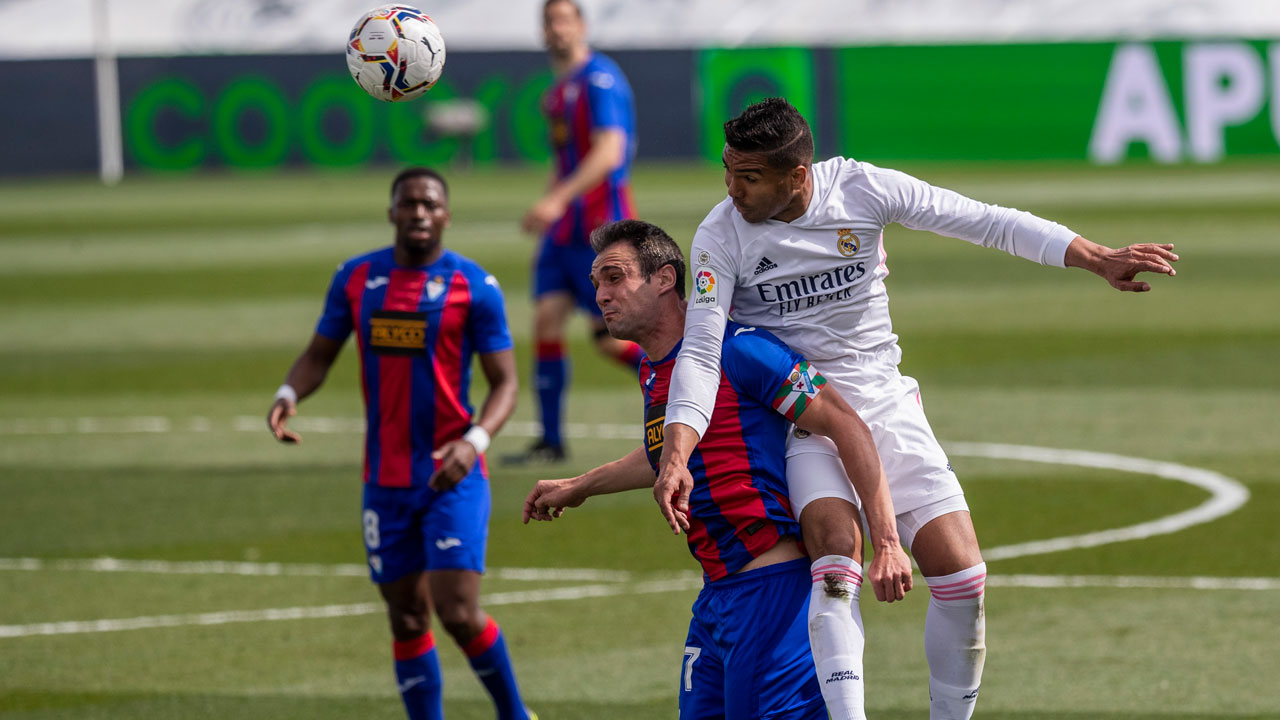 Real Madrid's Casemiro, right, duels for the ball with Eibar's Kike Garcia during the Spanish La Liga soccer match between Real Madrid and Eibar. (Bernat Armangue/AP)