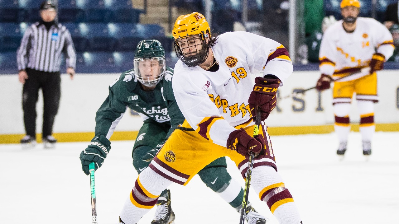 Minnesota's Scott Reedy (19) makes his way into the offensive zone against Michigan State during a college hockey game Sunday, March 14, 2021, in South Bend, Ind. (Michael Caterina/South Bend Tribune via AP)