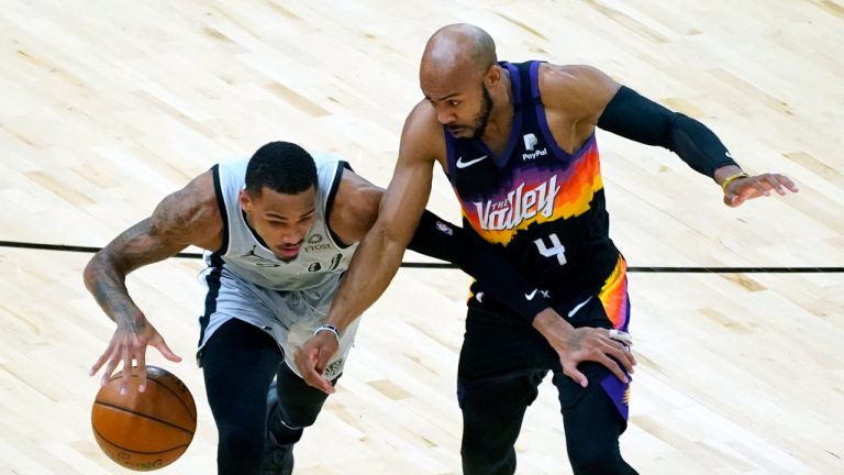 Phoenix Suns guard Jevon Carter (4) pressures San Antonio Spurs guard Dejounte Murray during the first half of an NBA basketball game Saturday, April 17, 2021, in Phoenix. (Rick Scuteri/AP)