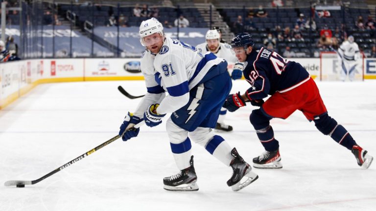 Tampa Bay Lightning forward Steven Stamkos, left, controls the puck next to Columbus Blue Jackets forward Alexandre Texier during the first period an NHL hockey game in Columbus, Ohio, Thursday, April 8, 2021. (AP Photo/Paul Vernon)