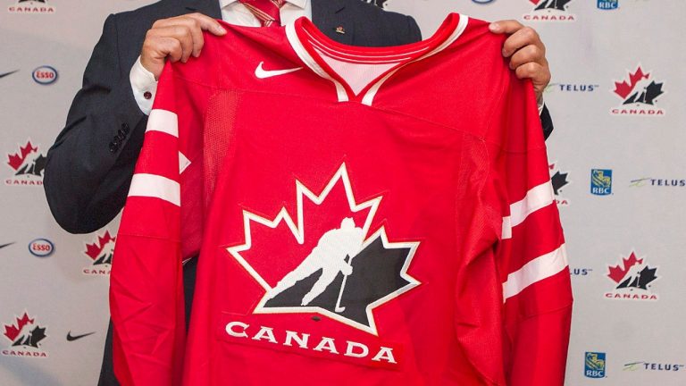 A Team Canada hockey jersey is held by Dominique Ducharme. (Graham Hughes/CP)