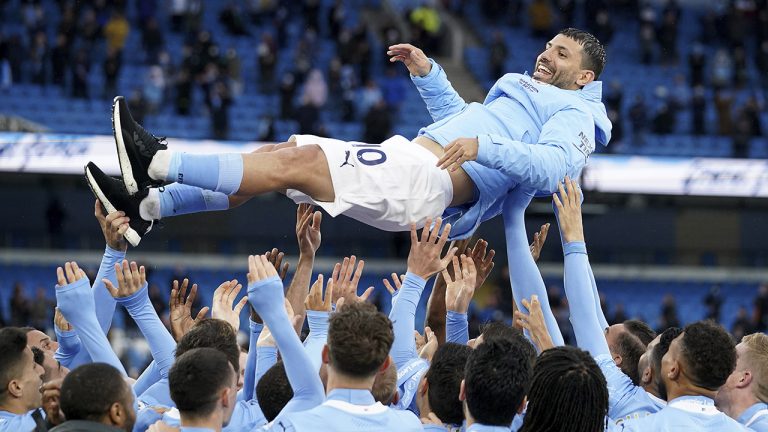 Manchester City players throw teammate Manchester City's Sergio Aguero in the air to celebrate winning the English Premier League title after the soccer match between Manchester City and Everton at the Etihad stadium in Manchester, Sunday, May 23, 2021.(AP Photo/Dave Thompson, Pool)
