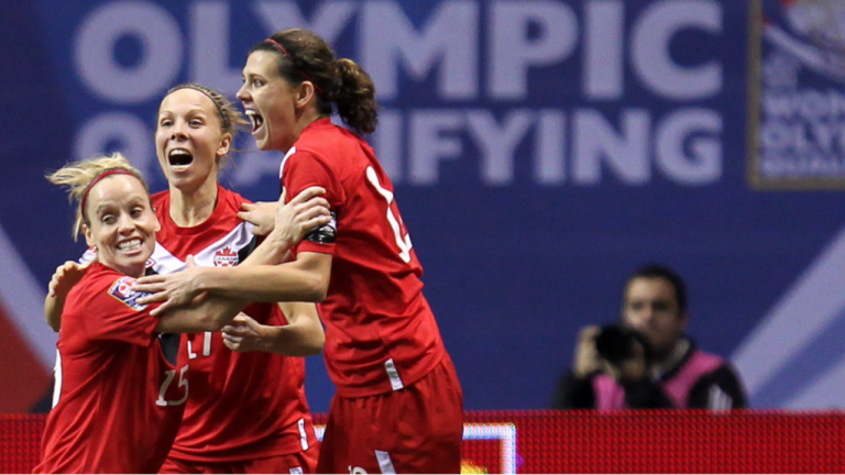 Canada's Christine Sinclair, right to left, celebrates her goal against Mexico with teammates Brittany Timko and Kelly Parker during the second half of CONCACAF women's Olympic qualifying soccer at B.C. Place in Vancouver, B.C., Friday, Jan. 27, 2012. (Jonathan Hayward / CP)