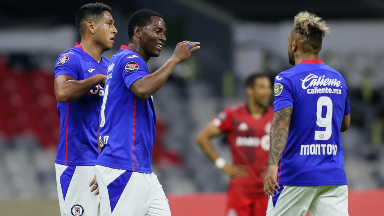Bryan Angulo of Mexico's Cruz Azul, centre, is congratulated by teammate Walter Montoya (9) after scoring their side's opening goal against Canada's Toronto FC during CONCACAF Champions League quarterfinal second leg soccer match at Azteca stadium in Mexico City, Tuesday, May 4, 2021. (Fernando Llano / AP)
