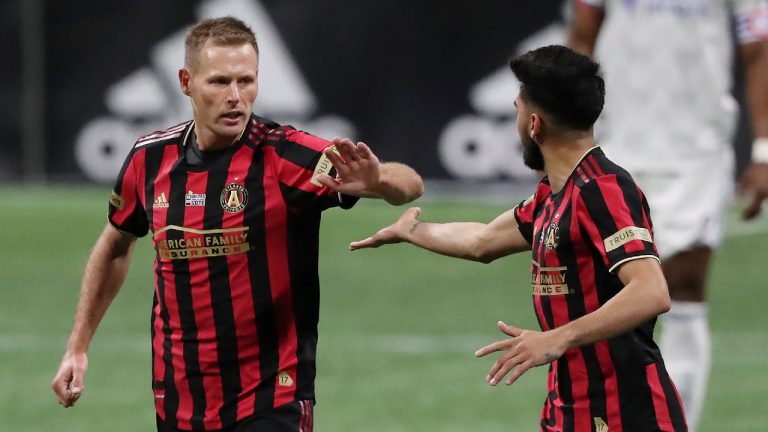 Atlanta United forward Adam Jahn, left, gets five from teammate Jurgen Locadia, right, after scoring a goal against FC Cincinnati during the 8th minute in an MLS match on Sunday, Nov 1, 2020, in Atlanta. (Curtis Compton/Atlanta Journal-Constitution via AP)
