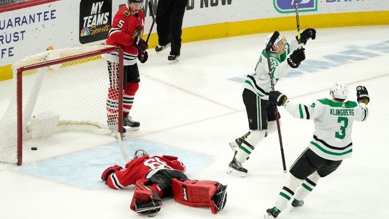 Dallas Stars' Jason Robertson (21) celebrates his winning goal with John Klingberg (3) as Chicago Blackhawks goaltender Collin Delia and Connor Murphy (5) look on during the overtime period of an NHL hockey game Monday, May 10, 2021, in Chicago. (AP Photo/Charles Rex Arbogast)