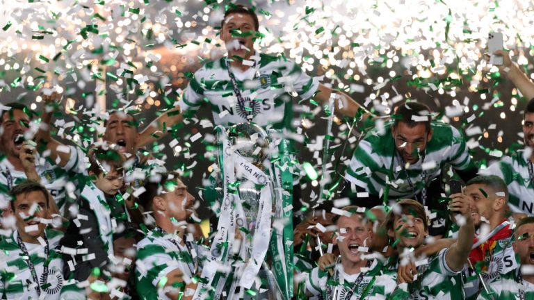 Sporting's captain Sebastian Coates lifts the trophy at the end of the Portuguese League soccer match between Sporting CP and Boavista FC at the Alvalade stadium in Lisbon, Tuesday, May 11, 2021. Sporting defeated Boavista 1-0 to clinch the championship title, with two more rounds still left to play. (AP Photo/Pedro Rocha)