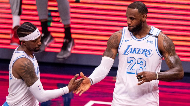 Los Angeles Lakers guard Kentavious Caldwell-Pope, left, and forward LeBron James (23) reacts after defeating the Indiana Pacers in an NBA basketball game in Indianapolis, Saturday, May 15, 2021. (AP Photo/Doug McSchooler)
