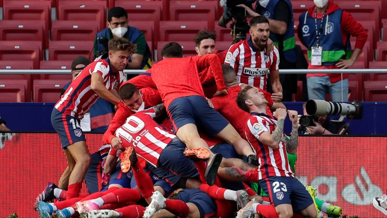 Atletico Madrid players celebrate after teammate Luis Suarez scored their side's second goal during the Spanish La Liga soccer match between Atletico Madrid and Osasuna at the Wanda Metropolitano stadium in Madrid, Spain, Sunday, May 16, 2021. (Manu Fernandez/AP)