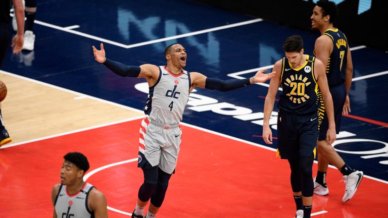 Washington Wizards guard Russell Westbrook (4) reacts next to Indiana Pacers forward Doug McDermott (20) and guard Malcolm Brogdon (7) during the second half of an NBA basketball Eastern Conference play-in game Thursday, May 20, 2021, in Washington. (AP Photo/Nick Wass)