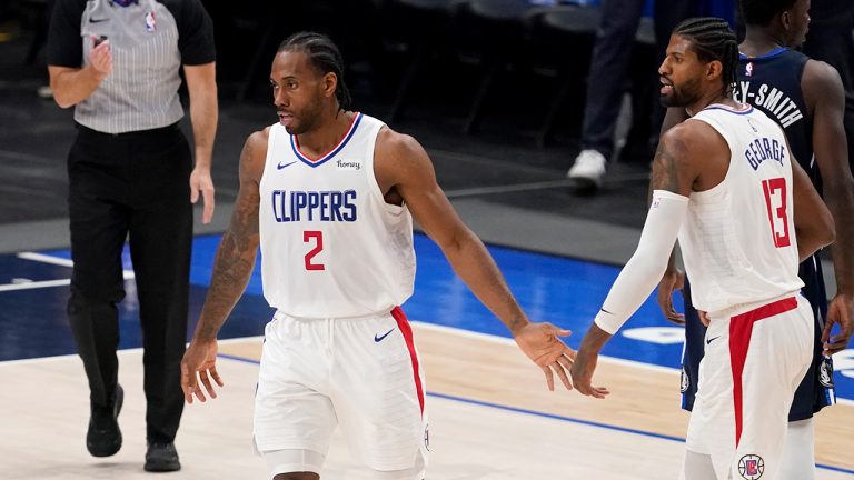Los Angeles Clippers' Kawhi Leonard (2) and Paul George (13) celebrate a basket in the closing seconds of Game 3 of an NBA basketball first-round playoff series against the Dallas Mavericks in Dallas, Friday, May 28, 2021. (Tony Gutierrez/AP)