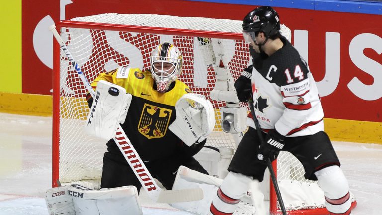 Canada's Adam Henrique, right, looks on as Germany's goaltender Mathias Niederberger blocks a shot during the Ice Hockey World Championship group B match between Germany and Canada at the Arena in Riga, Latvia, Monday, May 24, 2021. (Sergei Grits/AP)