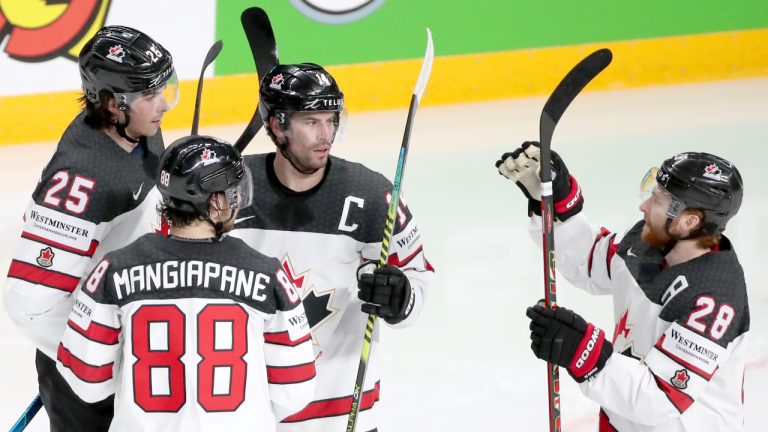 Canada's Owen Power, Andrew Mangiapane, Adam Henrique, and Connor Brown (L-R) celebrate scoring at the 2021 IIHF Ice Hockey World Championship. (Natalia Fedosenko/AP)