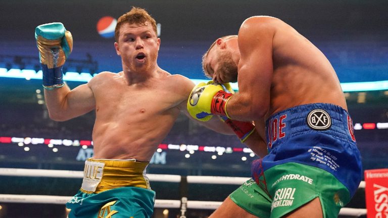 Canelo Alvarez, left, exchanges punches with Billy Joe Saunders during a unified super middleweight world championship boxing match, Saturday, May 8, 2021, in Arlington, Texas. (Jeffrey McWhorter/AP)