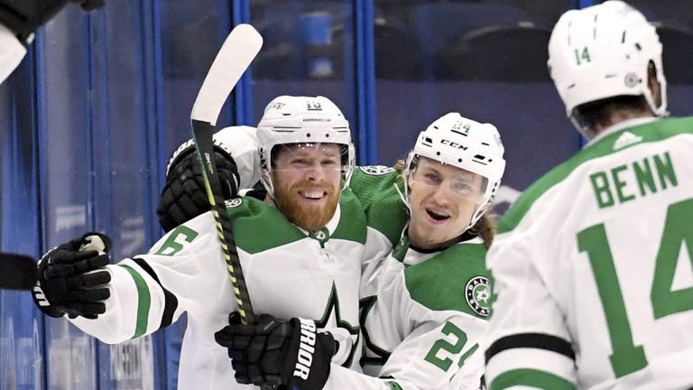 Dallas Stars center Joe Pavelski (16) and left wing Roope Hintz (24) celebrate a goal by Pavelski during the second period of an NHL hockey game against the Tampa Bay Lightning, Friday, May 7, 2021, in Tampa, Fla. (Jason Behnken/AP)
