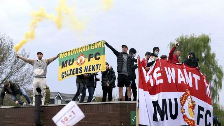 Fans holds up banners as they protest against the Glazer family, owners of Manchester United, before their Premier League match against Liverpool, Sunday, May 2, 2021. (Barrington Coombs/PA via AP)