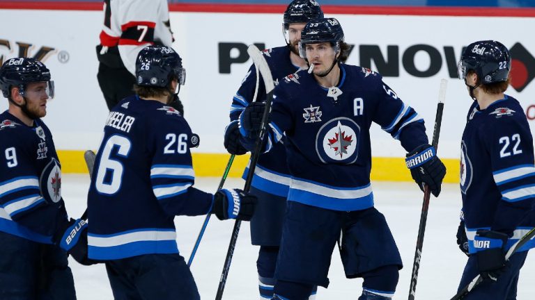 Winnipeg Jets' Mark Scheifele (55) celebrates his goal with Andrew Copp (9), Blake Wheeler (26), Josh Morrissey (44) and Mason Appleton (22) against the Ottawa Senators during third period NHL action in Winnipeg on Saturday, May 8, 2021. (John Woods/CP)