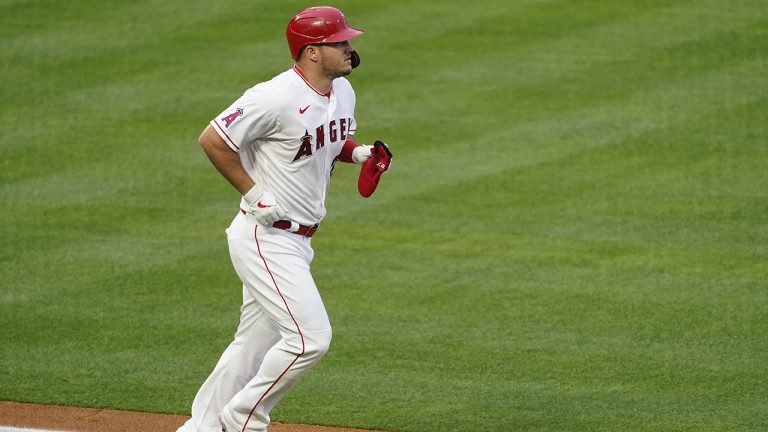 Los Angeles Angels' Mike Trout (27) is walked by Cleveland Indians starting pitcher Sam Hentges during the first inning of a baseball game Monday, May 17, 2021, in Los Angeles. (Ashley Landis/AP)