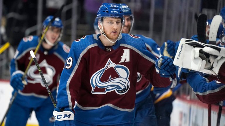 Colorado Avalanche center Nathan MacKinnon is congratulated as he passes the team box after scoring an empty-net goal against the St. Louis Blues late in the third period of Game 1 of an NHL hockey Stanley Cup first-round playoff series Monday, May 17, 2021, in Denver. Colorado won 4-1. (David Zalubowski/AP)