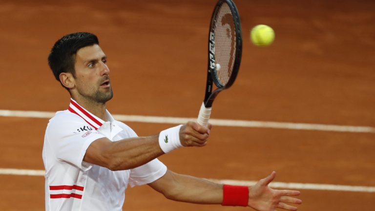 Novak Djokovic of Serbia returns the ball to Taylor Fritz of the United States during their match at the Italian Open tennis tournament, in Rome, Tuesday, May 11, 2021. (Alessandra Tarantino/AP)