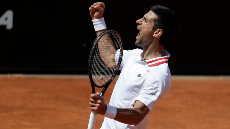Novak Djokovic celebrates after winning a point against Stefanos Tsitsipas during their quarterfinal match at the Italian Open. (Gregorio Borgia/AP)