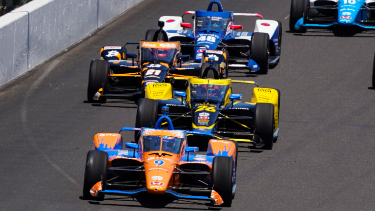 Scott Dixon, of New Zealand, leads the field into the first turn at the start the Indianapolis 500 auto race at Indianapolis Motor Speedway in Indianapolis, Sunday, May 30, 2021. (Paul Sancya / AP) 