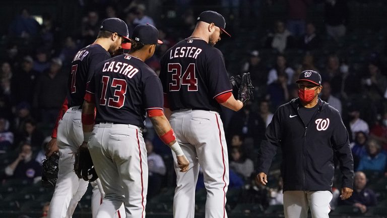 Washington Nationals starting pitcher Jon Lester (34) stands on the mound as manager Dave Martinez, right, takes him out of a baseball game. (David Banks/AP)