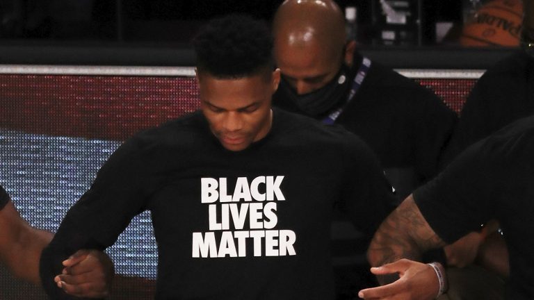 Russell Westbrook kneels during the national anthem before an NBA basketball game. (Mike Ehrmann/Pool Photo via AP)