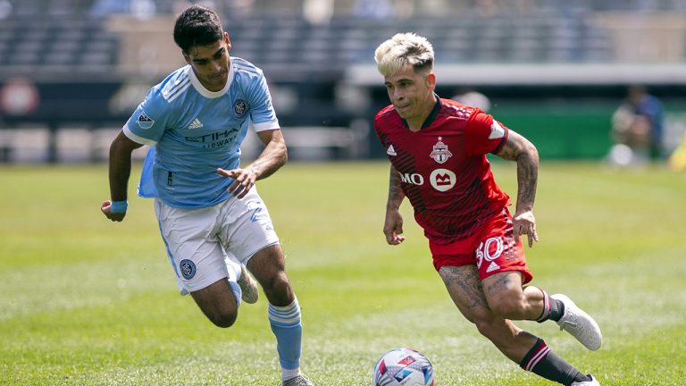 Toronto FC midfielder Yeferson Soteldo dribbles ahead of New York FC forward Andres Jasson. (Eduardo Munoz Alvarez/AP)