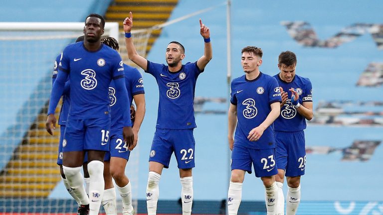 Chelsea's Hakim Ziyech, centre, celebrates scoring his side's first goal during the English Premier League soccer match between Manchester City and Chelsea at the Etihad Stadium in Manchester, Saturday, May 8, 2021.(Martin Rickett/Pool via AP)