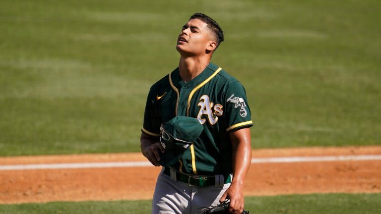 Oakland Athletics pitcher Jesus Luzardo walks to the dugout. (AP Photo/Marcio Jose Sanchez)