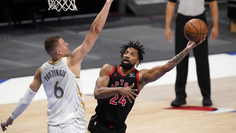 Dallas Mavericks center Kristaps Porzingis (6) defends against a shot by Toronto Raptors center Khem Birch (24) in the second half of an NBA basketball game in Dallas, Friday, May 14, 2021. (AP Photo/Tony Gutierrez)