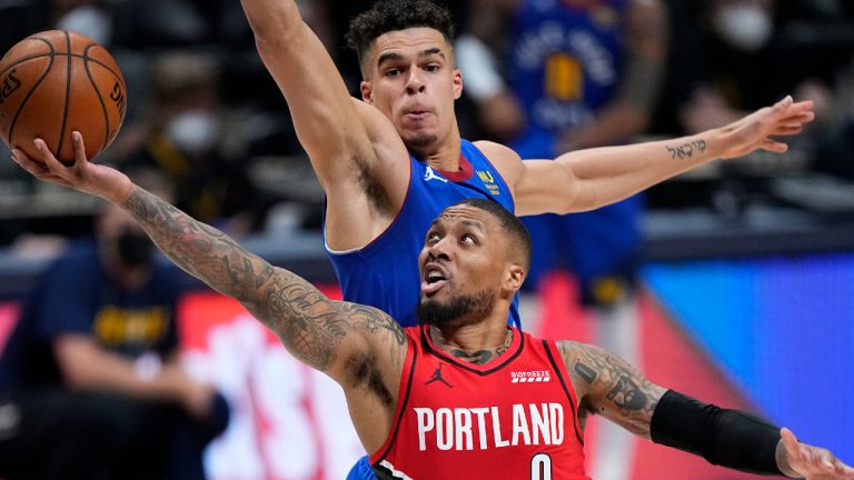 Portland Trail Blazers guard Damian Lillard (0) shoots next to Denver Nuggets forward Michael Porter Jr. (1) during the second half of Game 1 of a first-round NBA basketball playoff series Saturday, May 22, 2021, in Denver. (Jack Dempsey/AP)