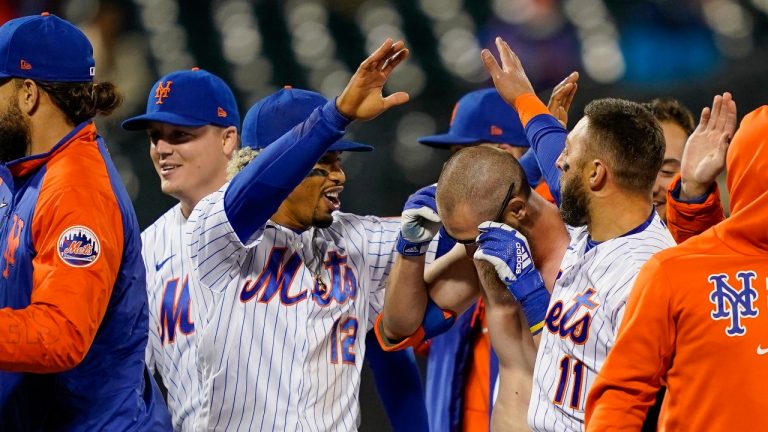 New York Mets' Francisco Lindor (12) celebrates with Patrick Mazeika, center right, who had his jersey removed by his teammates as they celebrate after Pete Alonso scored the winning run against the Arizona Diamondbacks on a grounder by Mazeika in the 10th inning of a baseball game Friday, May 7, 2021, in New York. (AP Photo/John Minchillo)