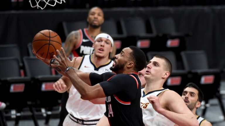 Portland Trail Blazers forward Norman Powell, left, drives to the basket on Denver Nuggets centre Nikola Jokic, right, during the second half of Game 4 of an NBA basketball first-round playoff series in Portland, Ore., Saturday, May 29, 2021. The Blazers won 1115-95. (Steve Dykes/AP) 