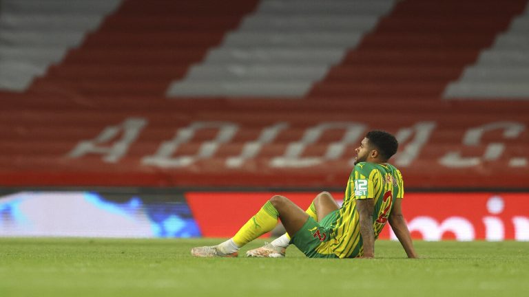 West Bromwich Albion's Darnell Furlong sits on the pitch in dejection at the end of the English Premier League soccer match between Arsenal and West Bromwich Albion at the Emirates Stadium in London, England, Sunday, May 9, 2021. (Richard Heathcote/ Pool via AP)