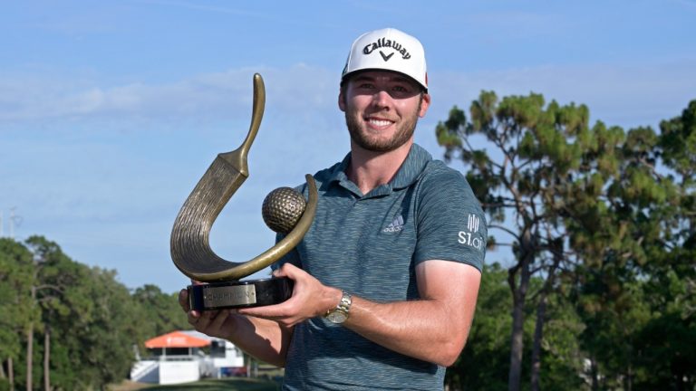 Sam Burns poses with the championship trophy after winning the Valspar Championship golf tournament, Sunday, May 2, 2021, in Palm Harbor, Fla. (Phelan M. Ebenhack/AP)