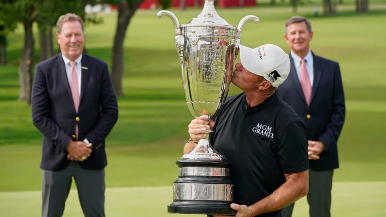 Alex Cejka kisses the Alfred S. Bourne Trophy after winning the Senior PGA Championship golf tournament Sunday, May 30, 2021, in Tulsa, Okla. (Sue Ogrocki/AP) 
