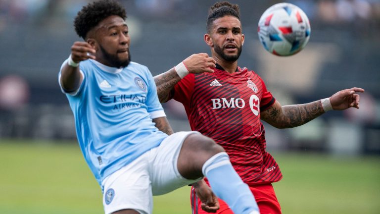 New York FC midfielder Chris Gloster, left, fights for the ball against Toronto FC forward Dom Dwyer during an MLS soccer match at Yankee Stadium on, Saturday, May 15, 2021. in New York. (Eduardo Munoz Alvarez/AP)
