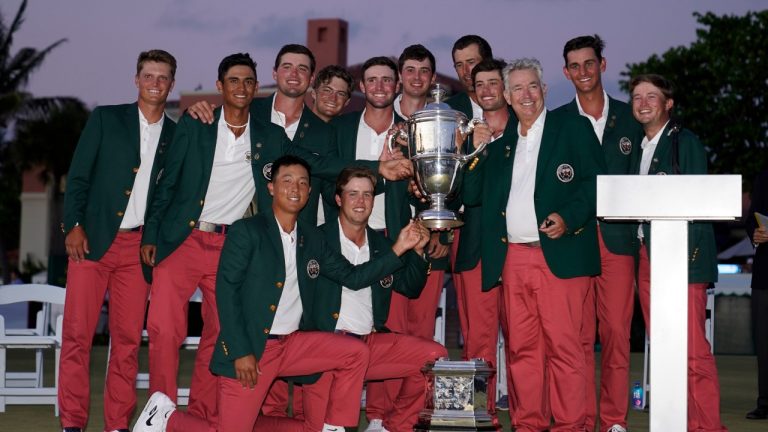 The USA team holds the trophy after winning the Walker Cup golf tournament against the Great Britain and Ireland team at the Seminole Golf Club on Sunday, May 9, 2021, in Juno Beach, Fla. (AP Photo/Brynn Anderson)