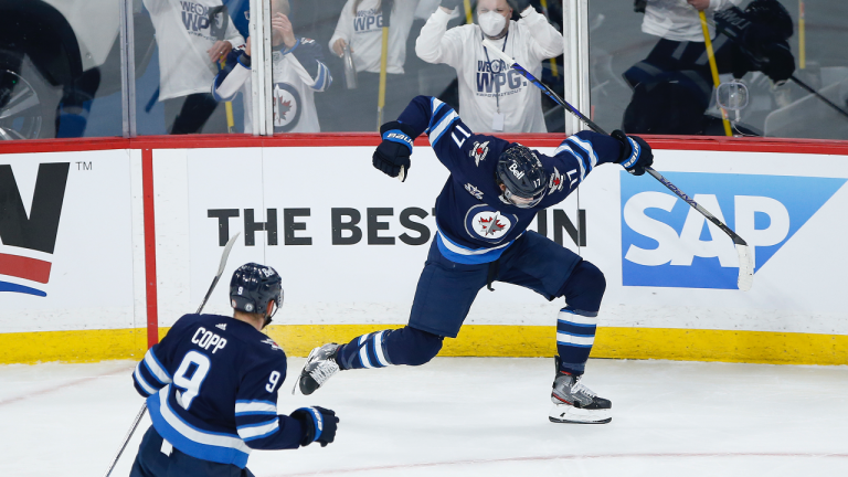 Winnipeg Jets' Adam Lowry (17) celebrates his goal with teammate Andrew Copp (9) during first period NHL Stanley Cup playoff hockey action against the Montreal Canadiens, in Winnipeg, Wednesday, June 2, 2021. (CP)