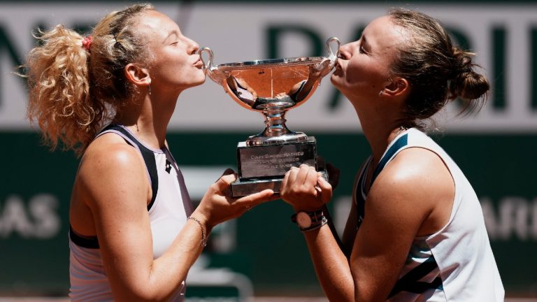 Czech Republic's Barbora Krejcikova, right, and compatriot Katerina Siniakova kiss the cup after defeating USA's Bethanie Mattek-Sands and Poland's Iga Swiatek in their women's doubles final match of the French Open. (Thibault Camus/AP)