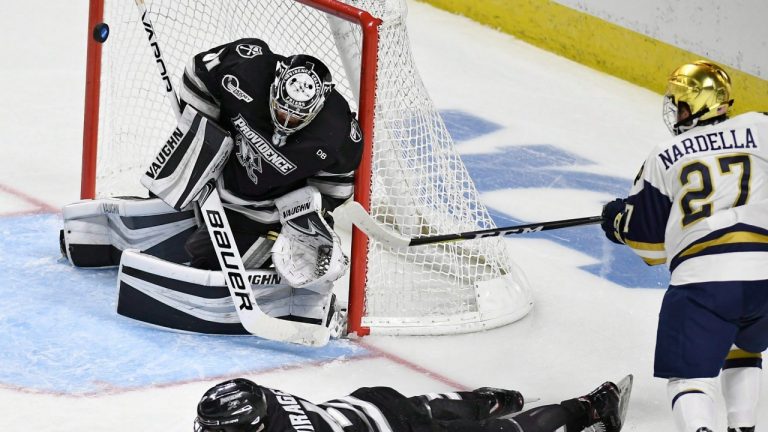 Providence goaltender Hayden Hawkey (31) deflects a shot by newly signed Washington Capital, Notre Dame's Bobby Nardella. (Jessica Hill/AP)